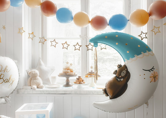 Foil balloon with teddy bear sleeping on the moon